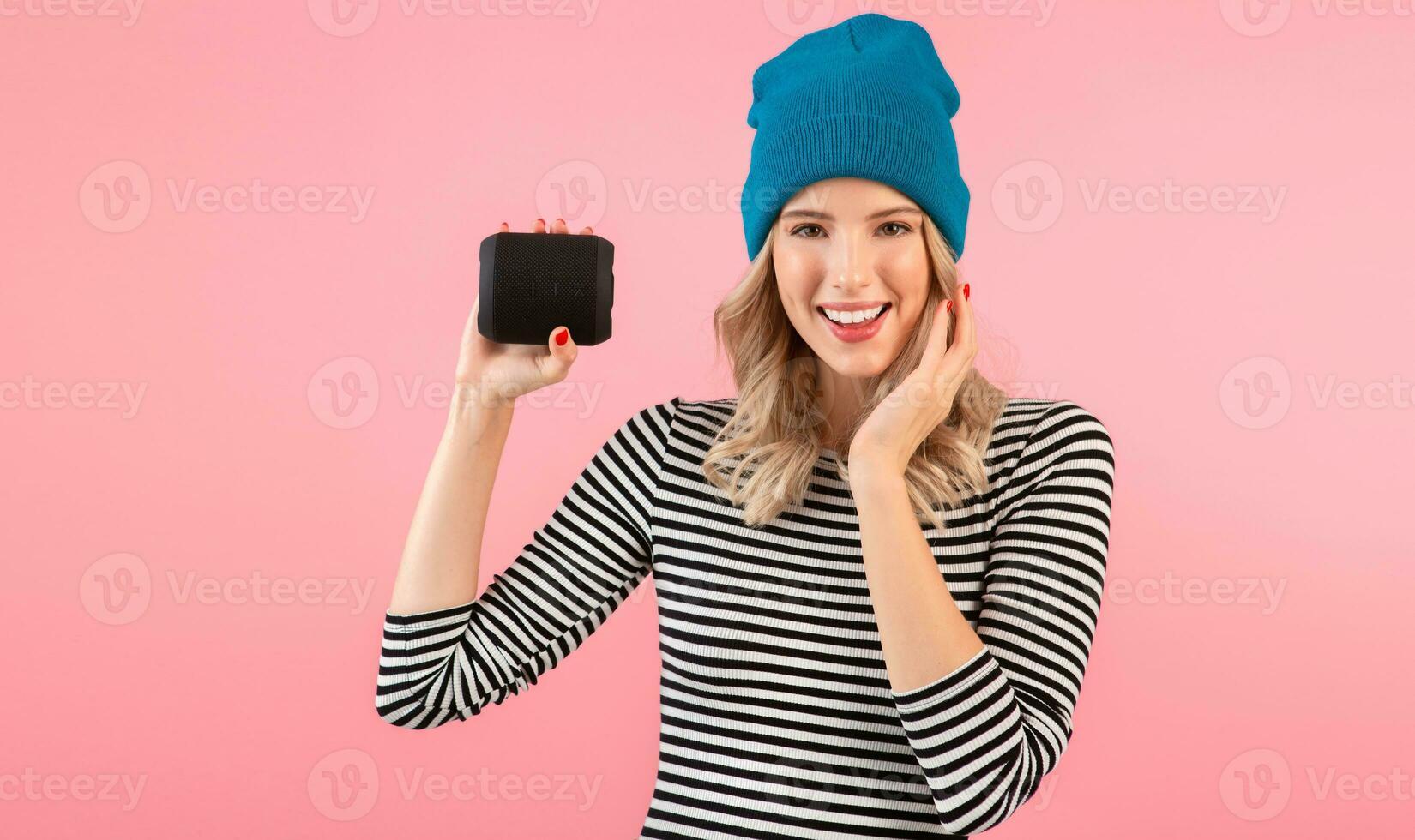 young woman holding music speaker photo