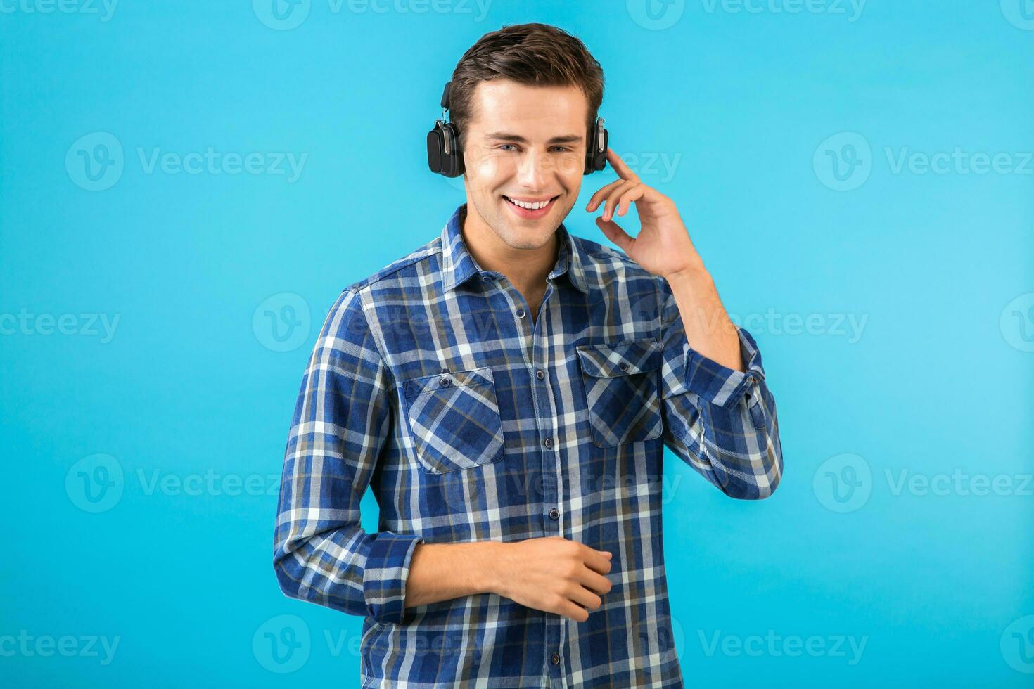 stylish young man listening to music on wireless headphones photo