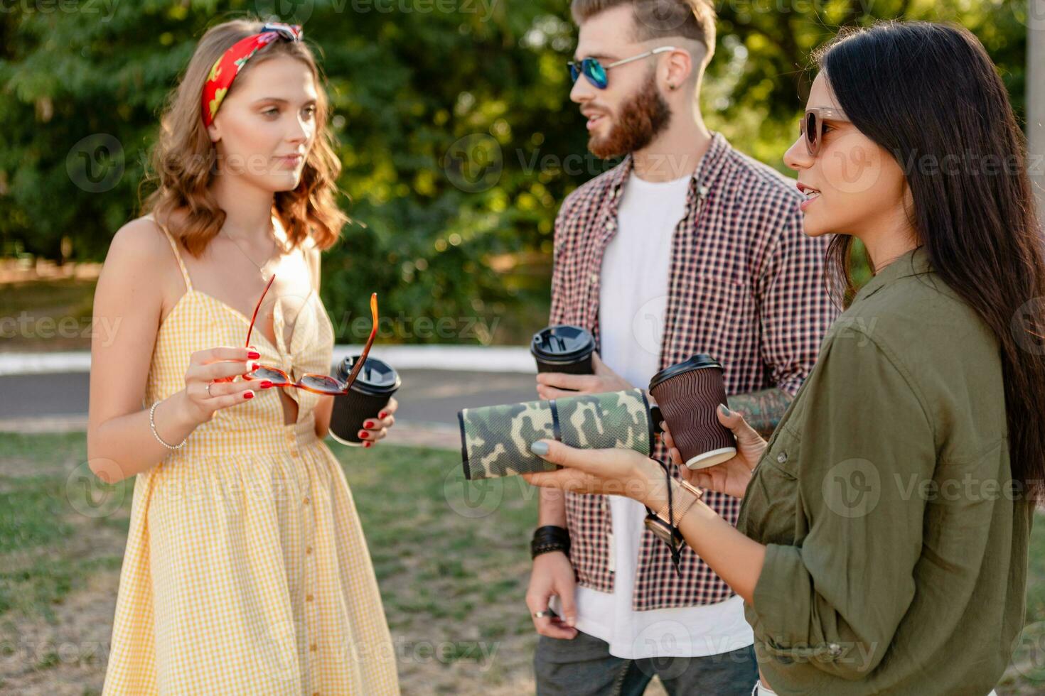 company of friends having fun together in park listening to music photo
