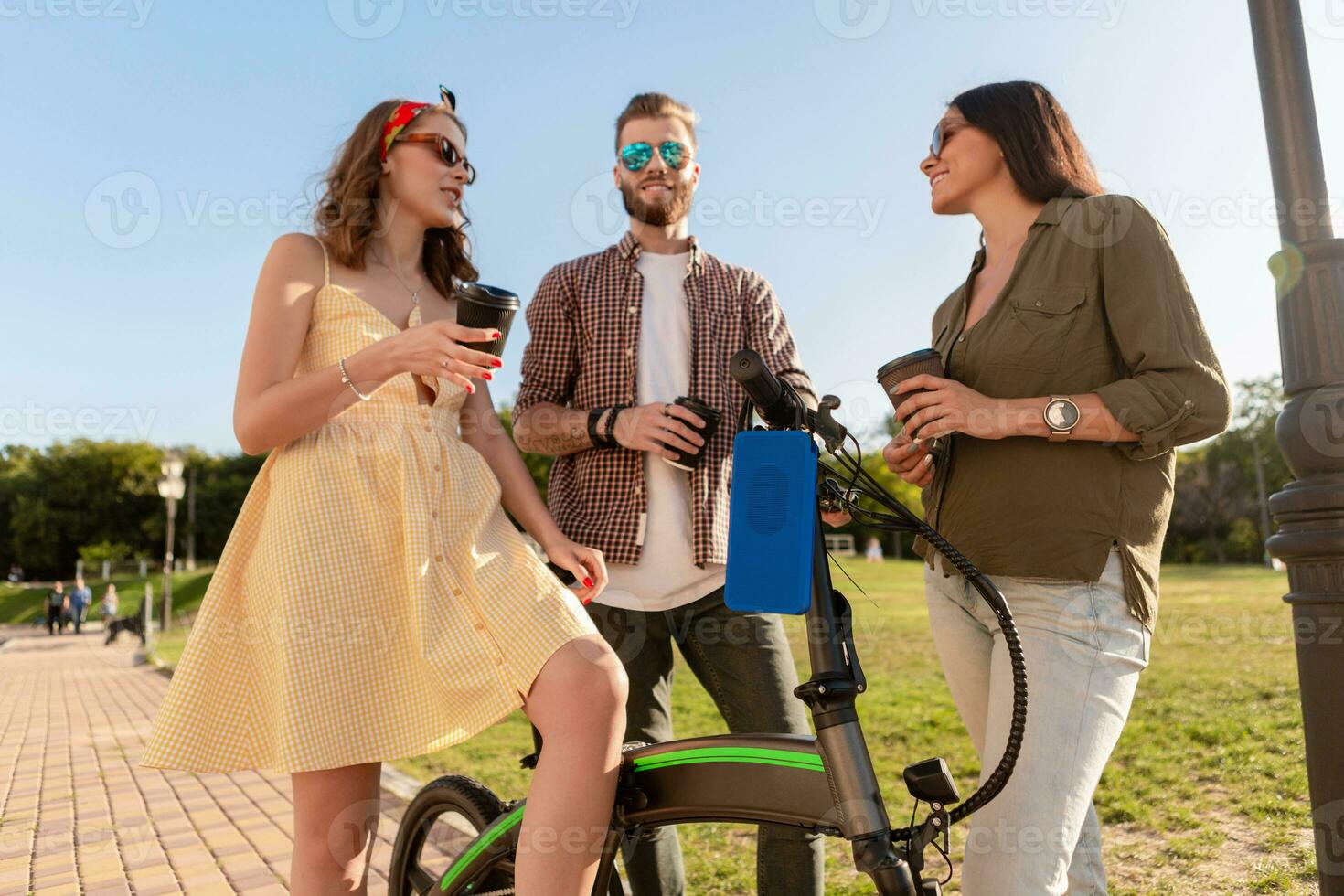 company of friends having fun together in park listening to music photo