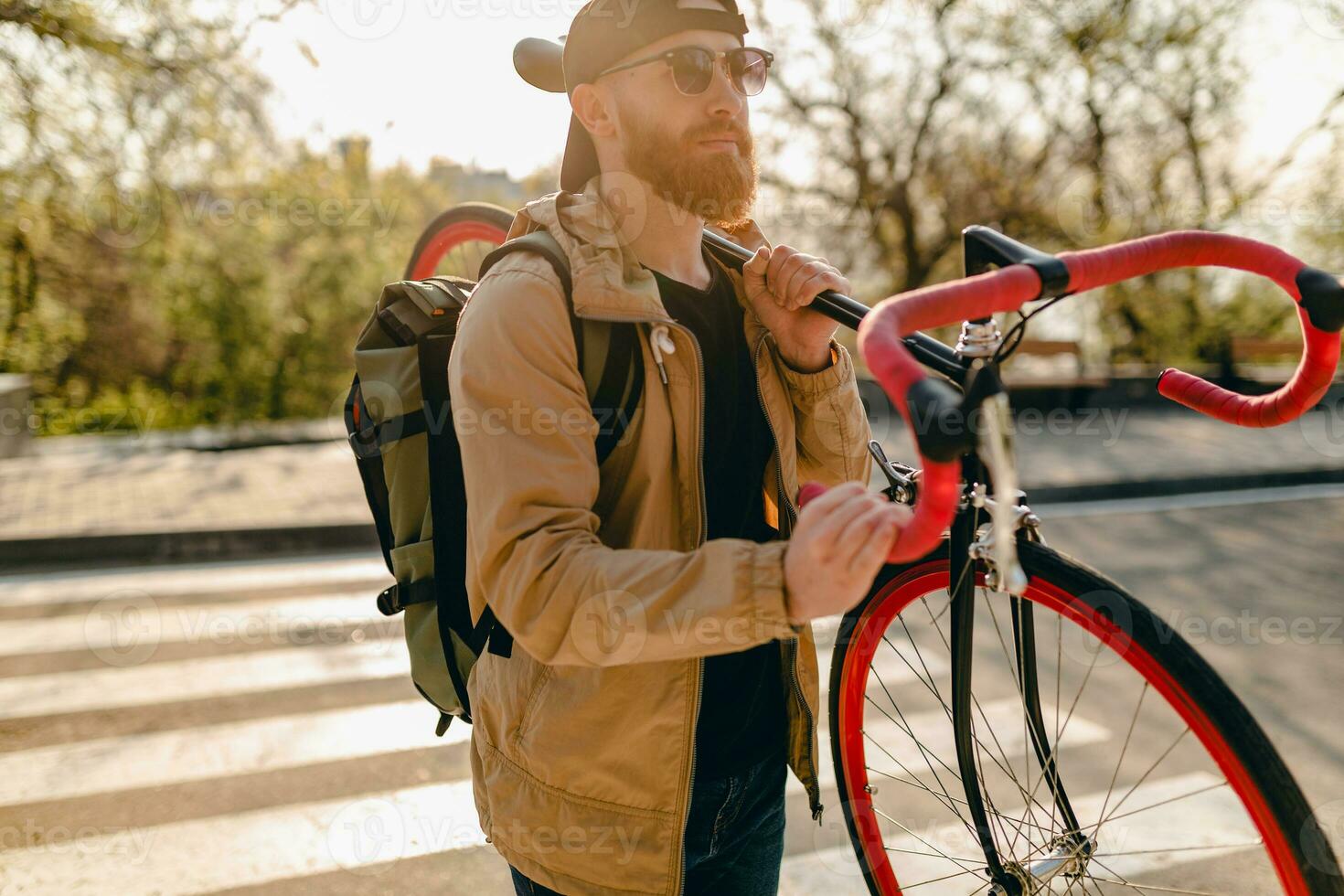 handsome bearded man traveling with bicycle in morning photo