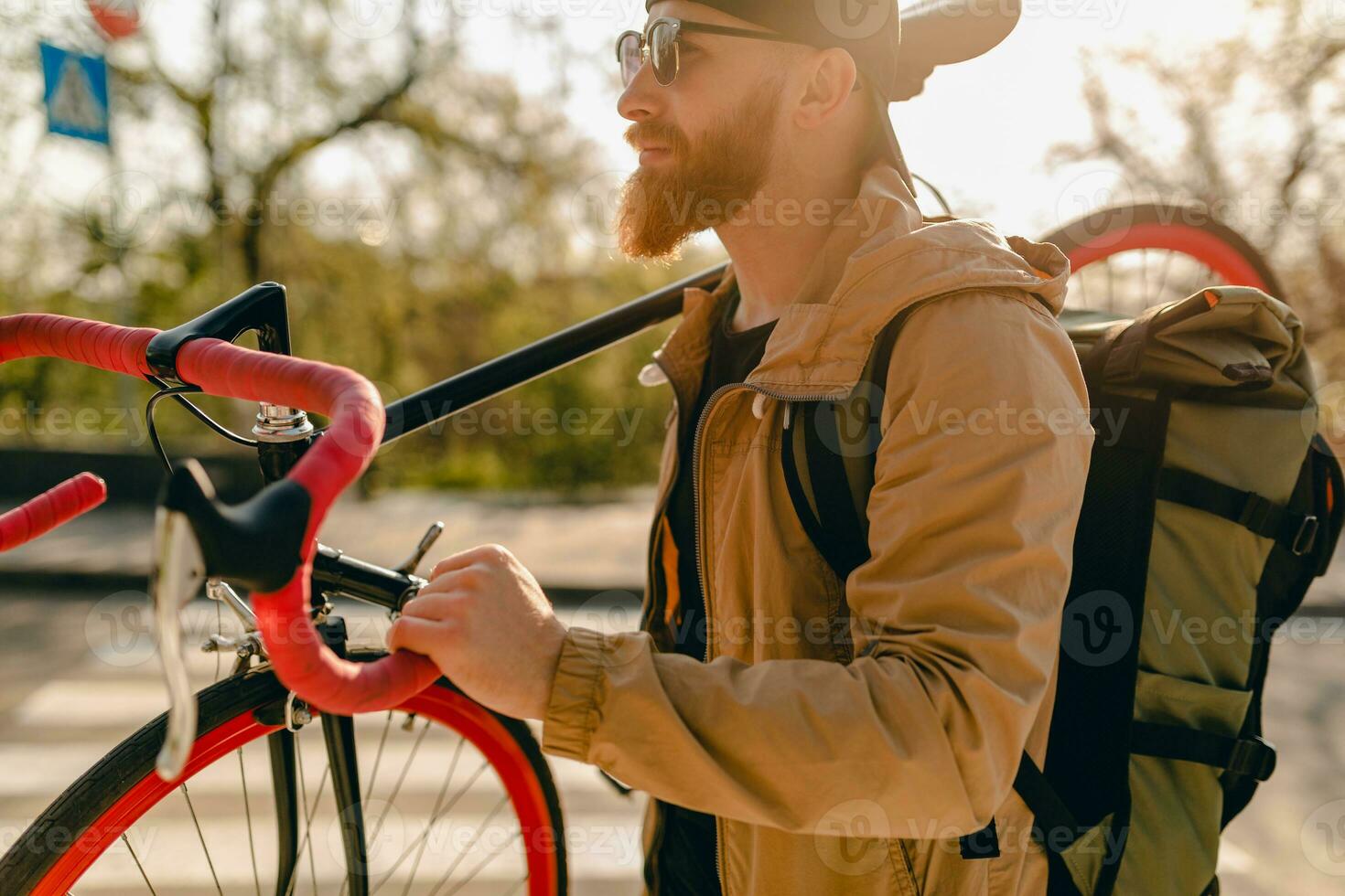 handsome bearded man traveling with bicycle in morning photo