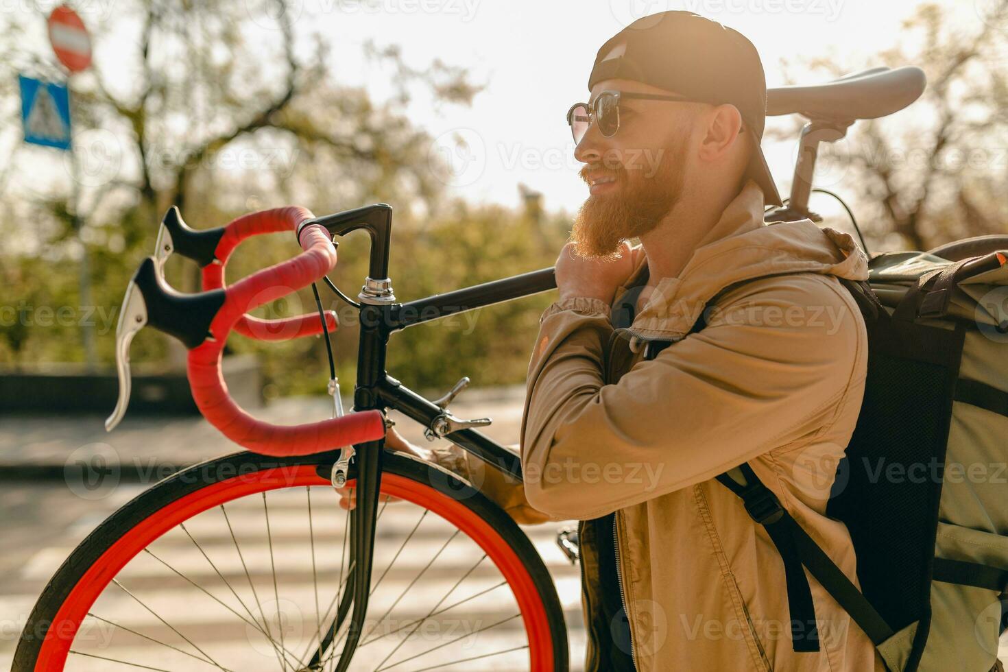 handsome bearded man traveling with bicycle in morning photo