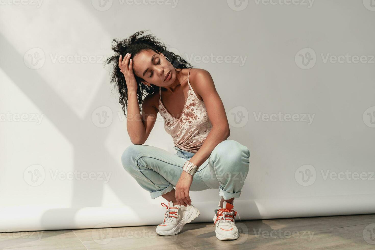 attractive black african american woman in stylish outfit on white background photo