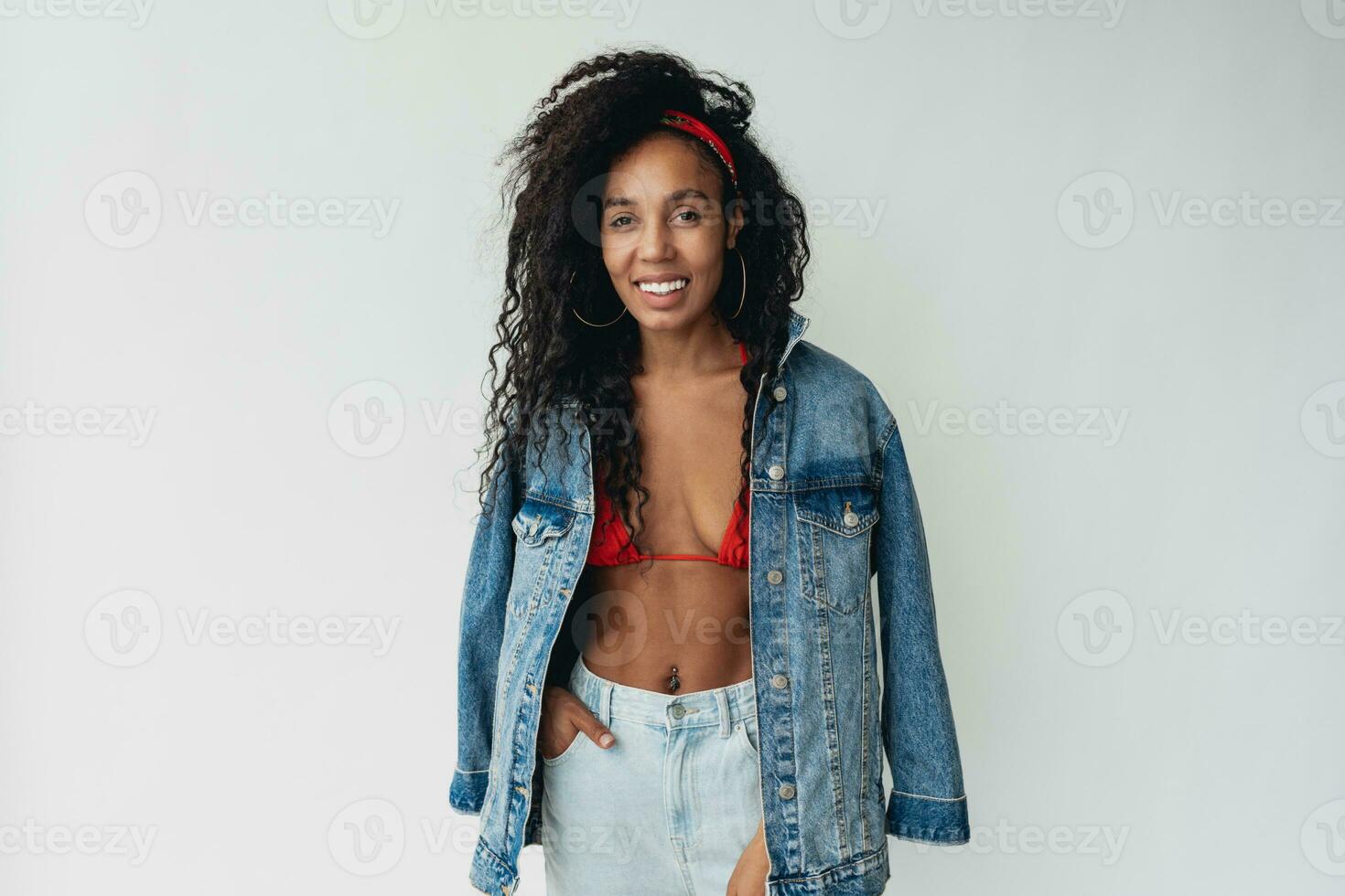 attractive black african american woman posing in stylish hipster outfit on white background photo