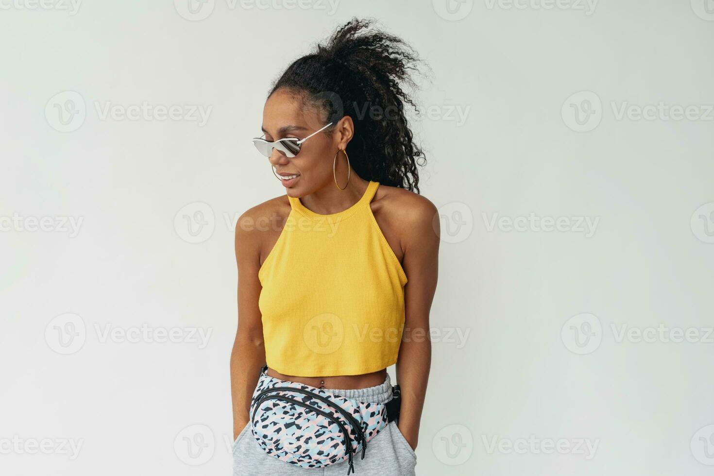 attractive black african american woman posing in stylish hipster outfit on white background photo