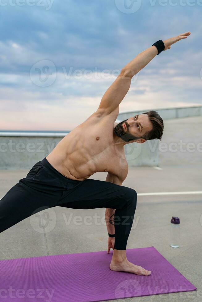 attractive hansome man with athletic strong body doing morning yoga asana  outdoors 29056509 Stock Photo at Vecteezy