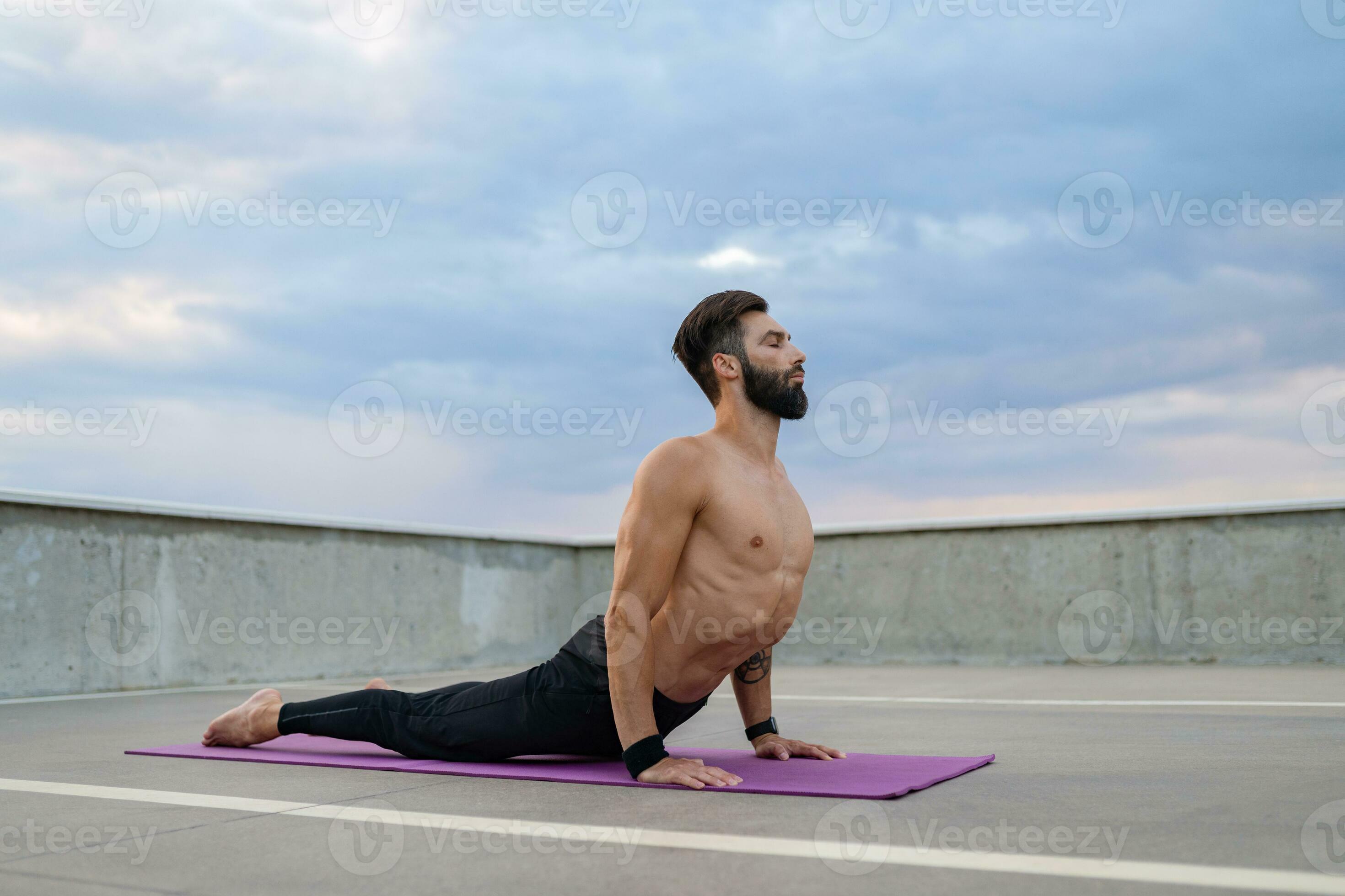 attractive hansome man with athletic strong body doing morning yoga asana  outdoors 29056509 Stock Photo at Vecteezy