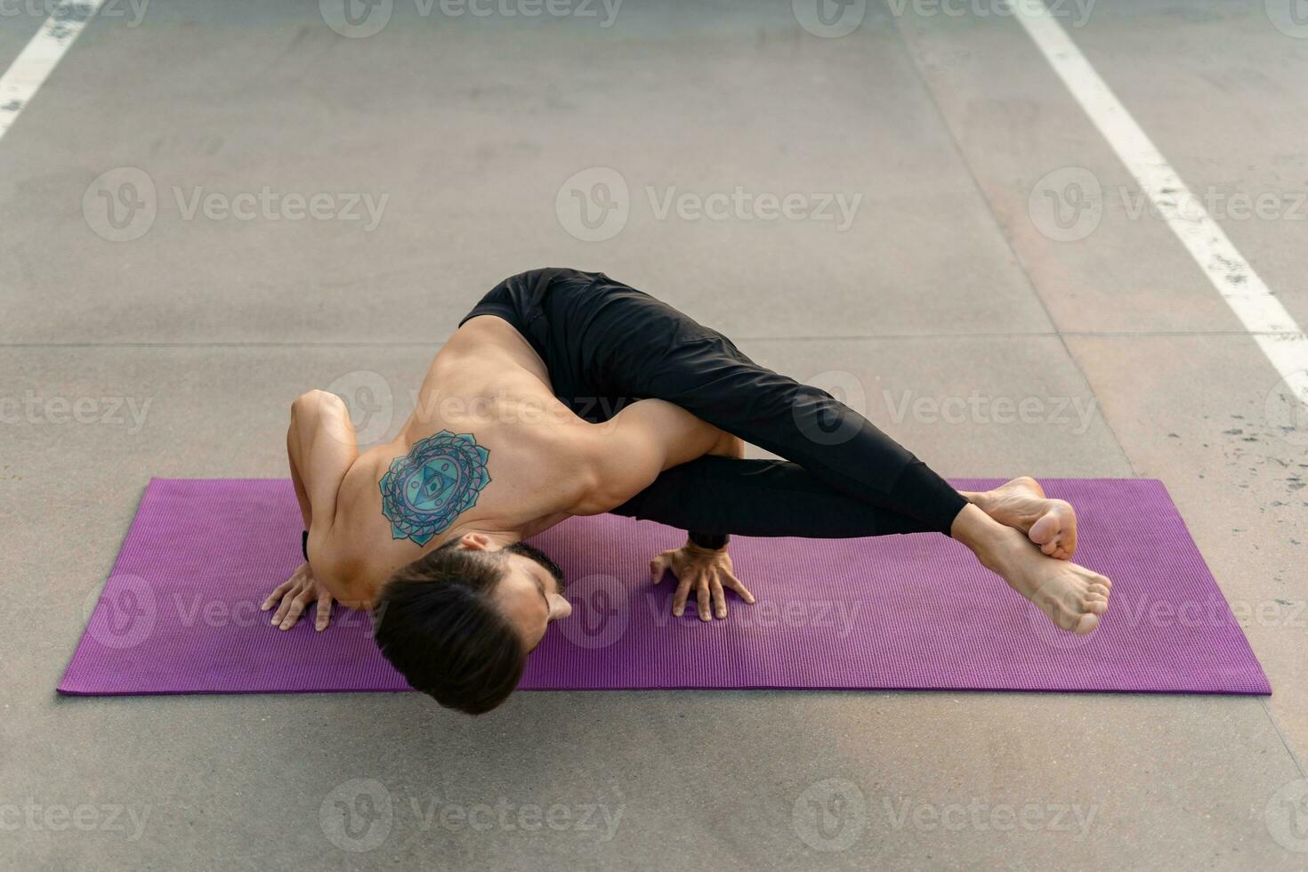 attractive hansome man with athletic strong body doing morning yoga asana outdoors photo