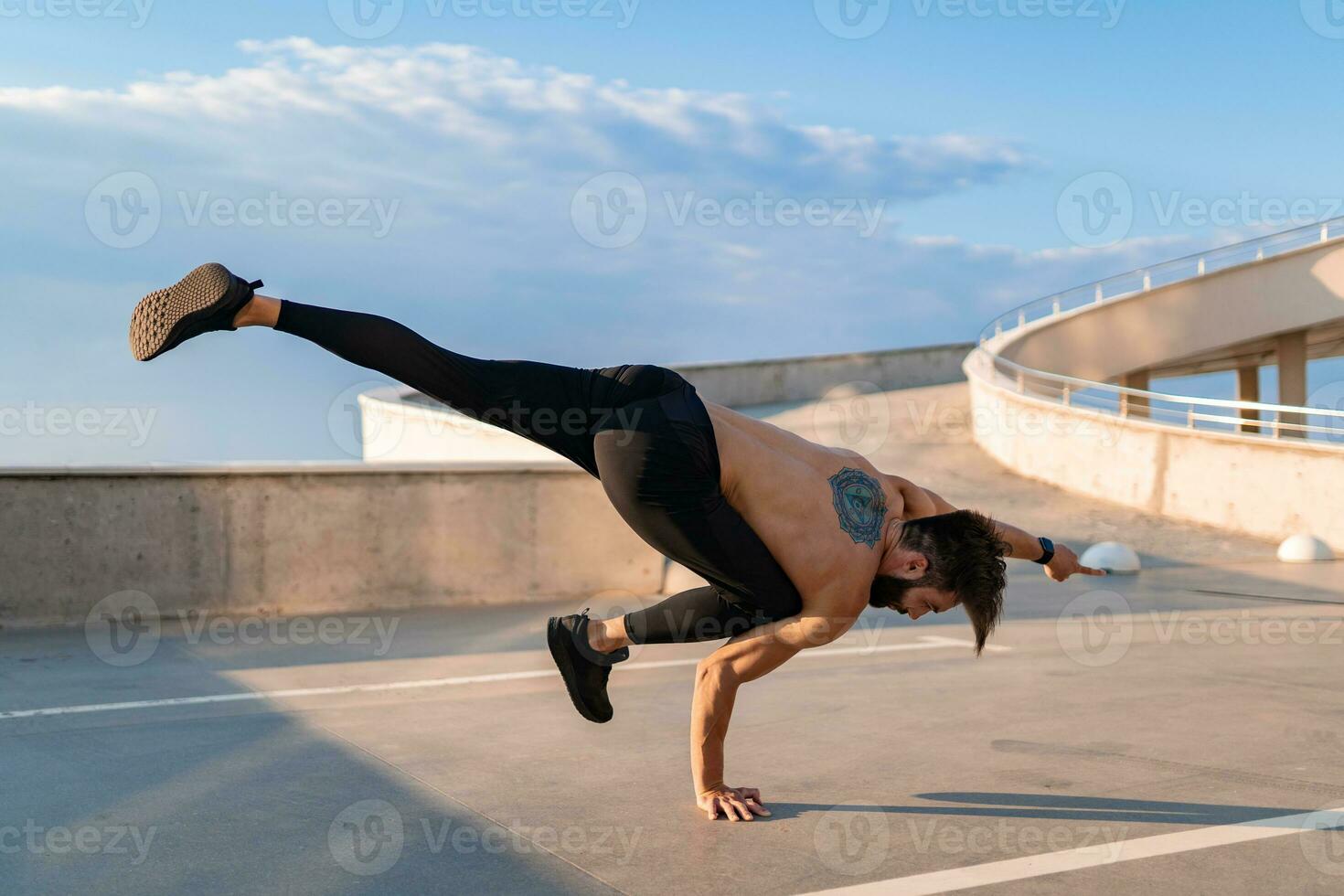 attractive hansome man with athletic strong body doing morning yoga asana outdoors photo