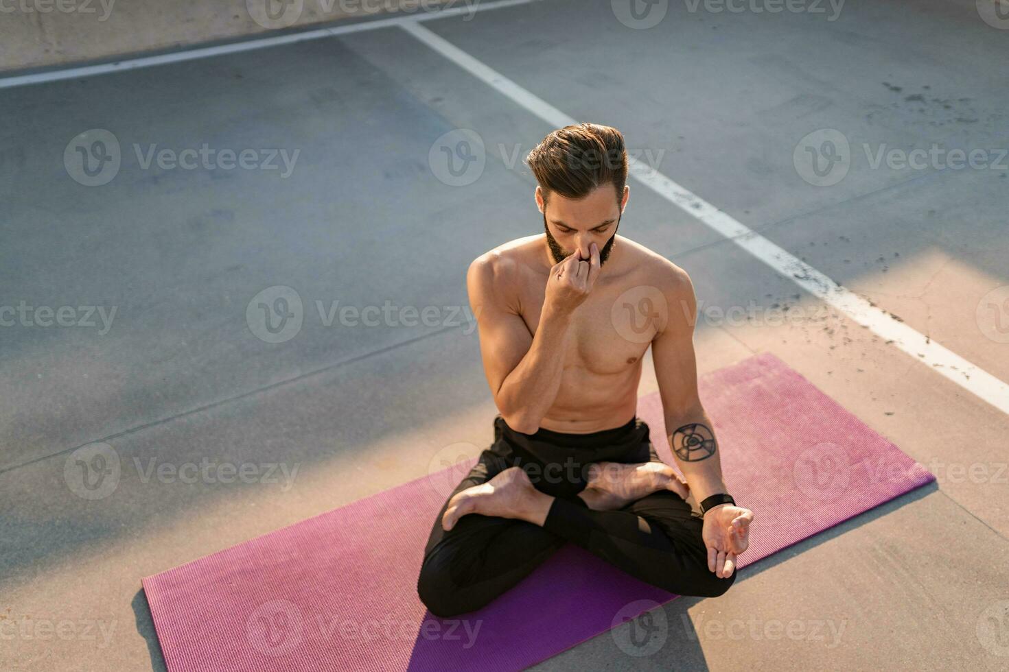 attractive hansome man with athletic strong body doing morning yoga dzen meditation photo