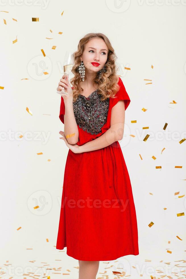 young stylish woman in red evening dress celebrating new year photo