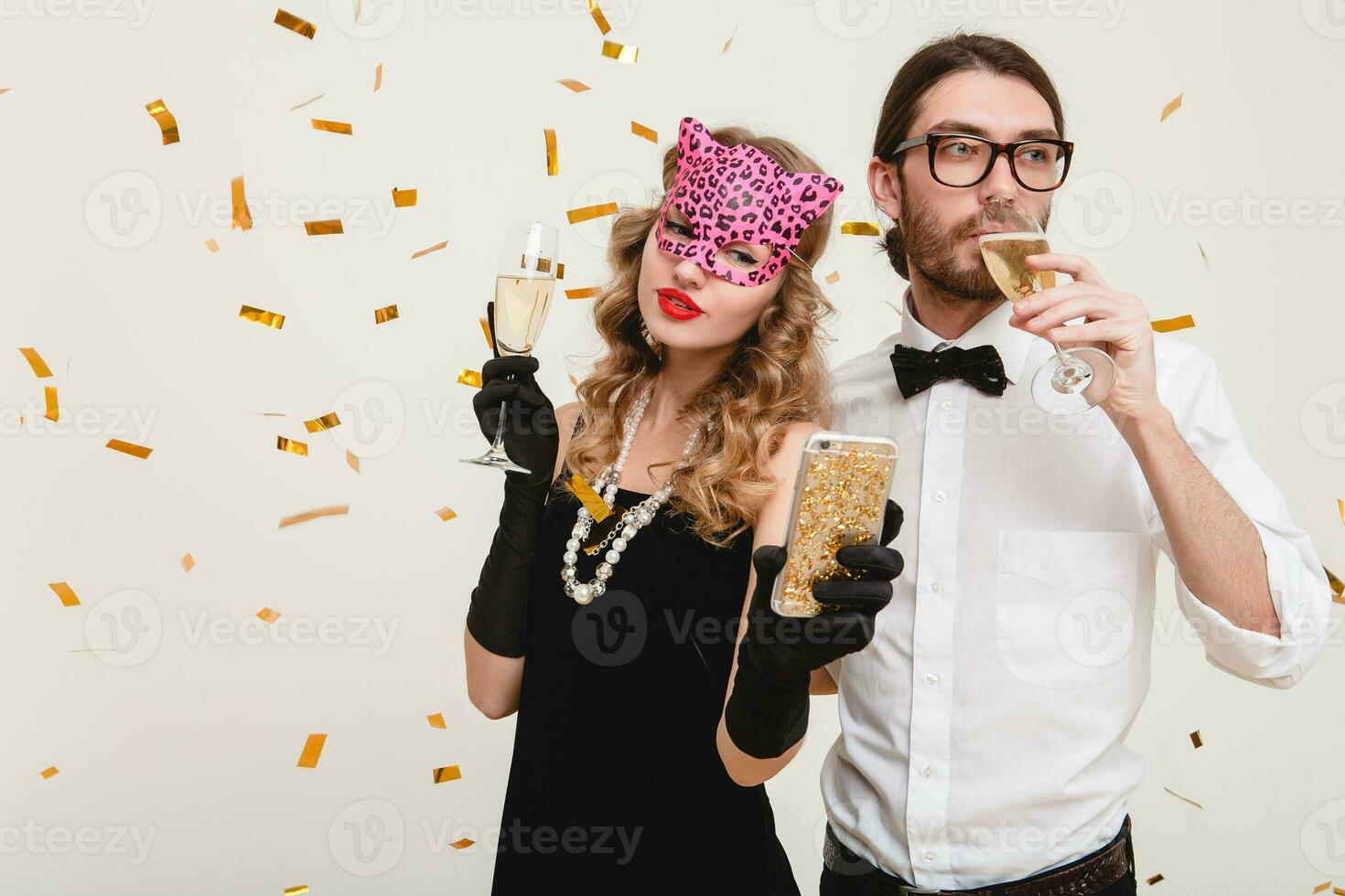 young stylish couple in love on white background holding glasses and drinking champagne photo