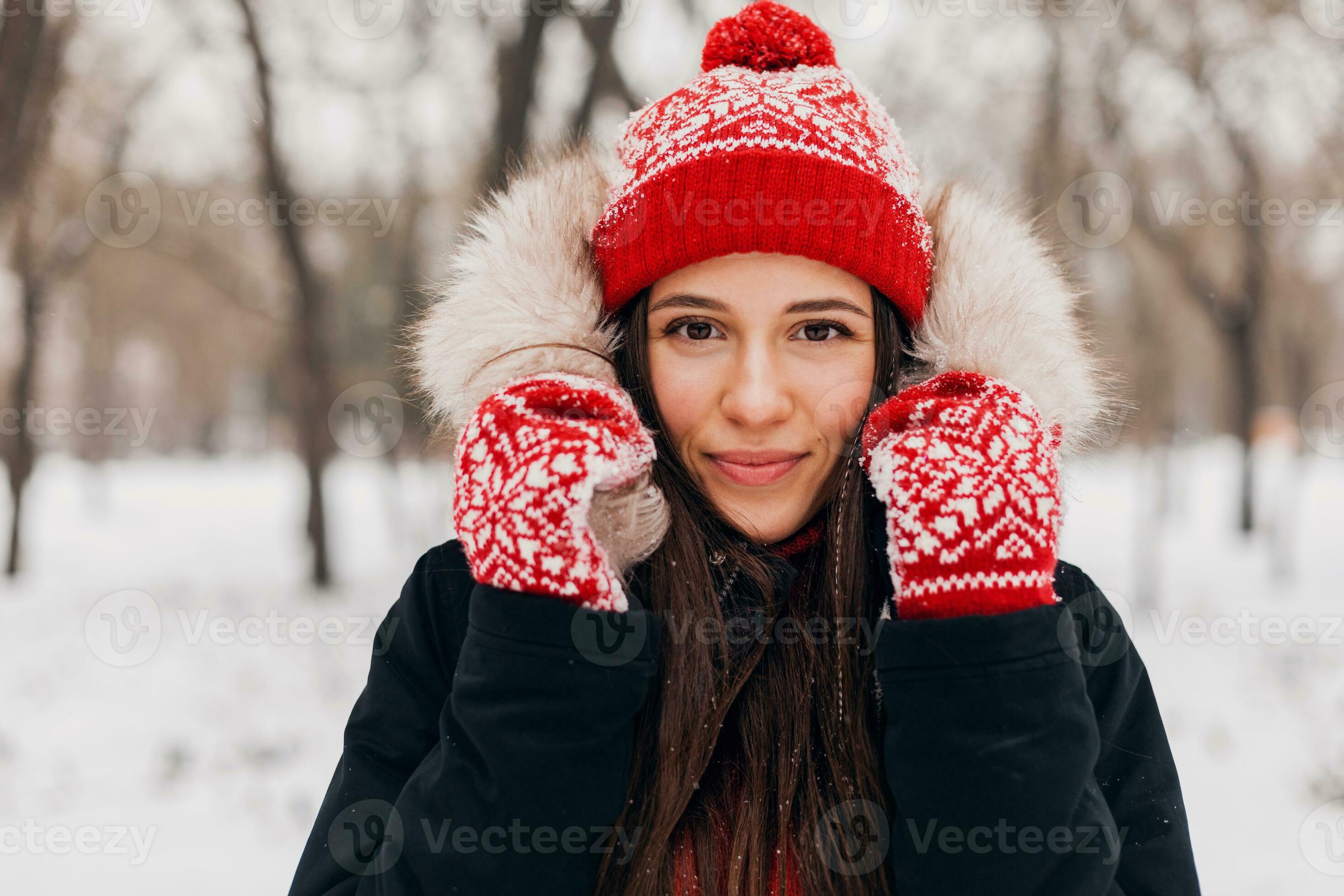 Portrait of a happy smiling young woman in winter clothes. Warm