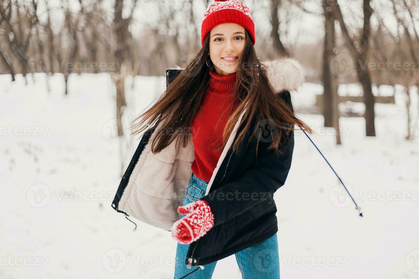 smiling woman having fun in winter park photo