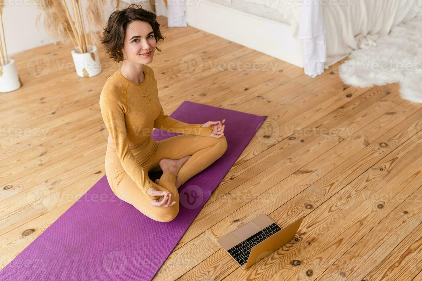 young pretty woman doing yoga at home photo