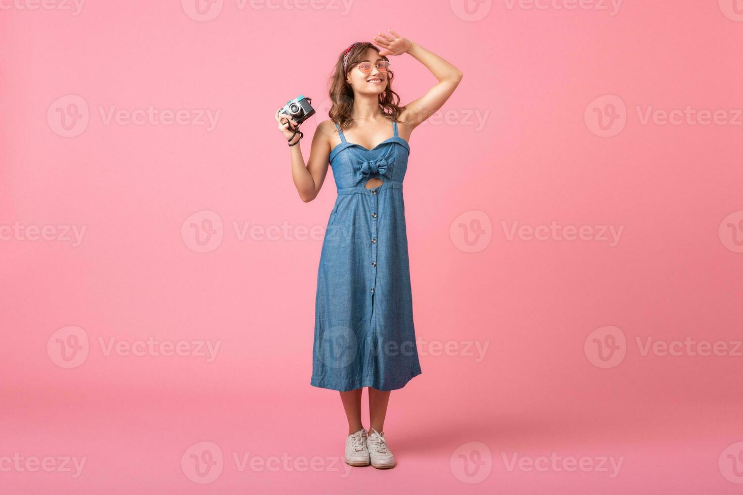 attractive smiling happy woman posing with vintage photo camera