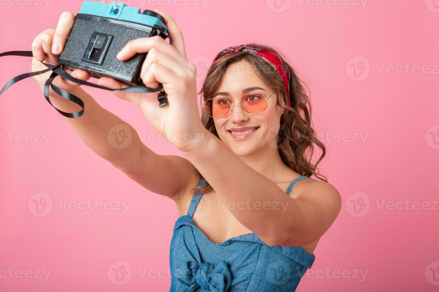 attractive smiling happy woman posing with vintage photo camera