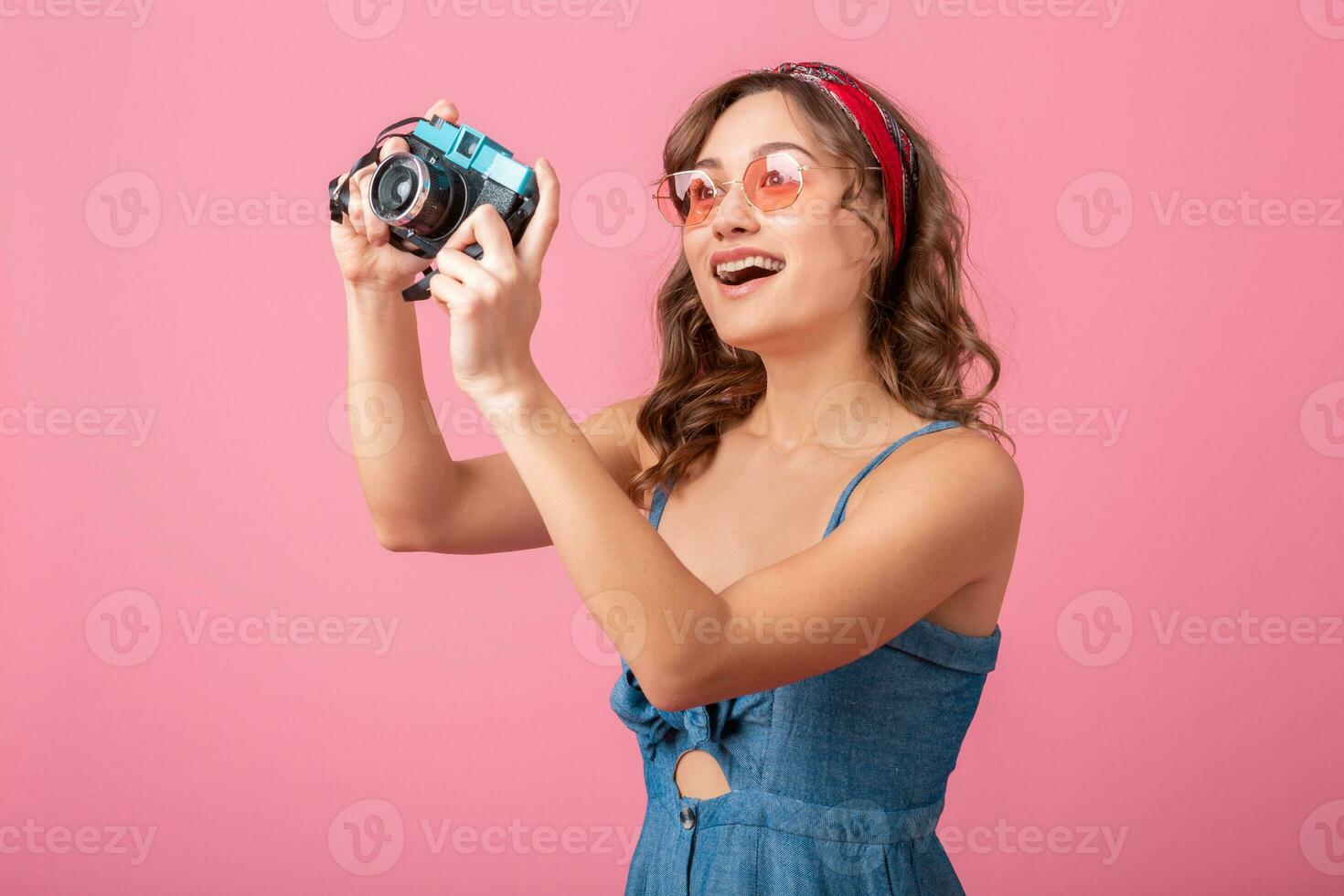 attractive smiling happy woman posing with vintage photo camera