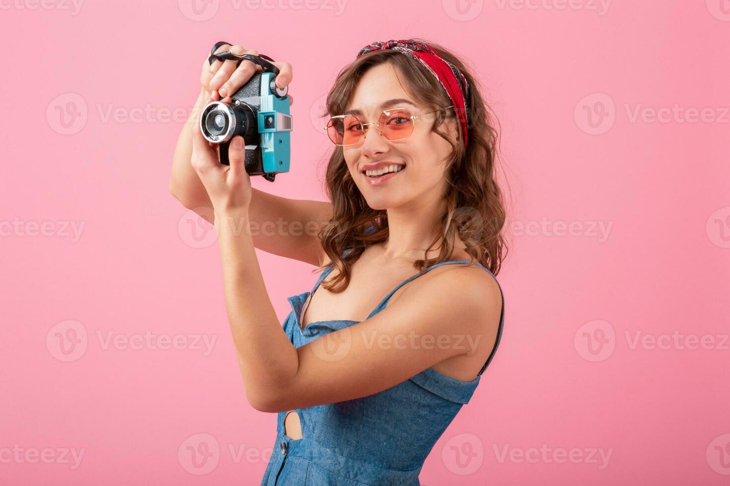 attractive smiling happy woman posing with vintage photo camera