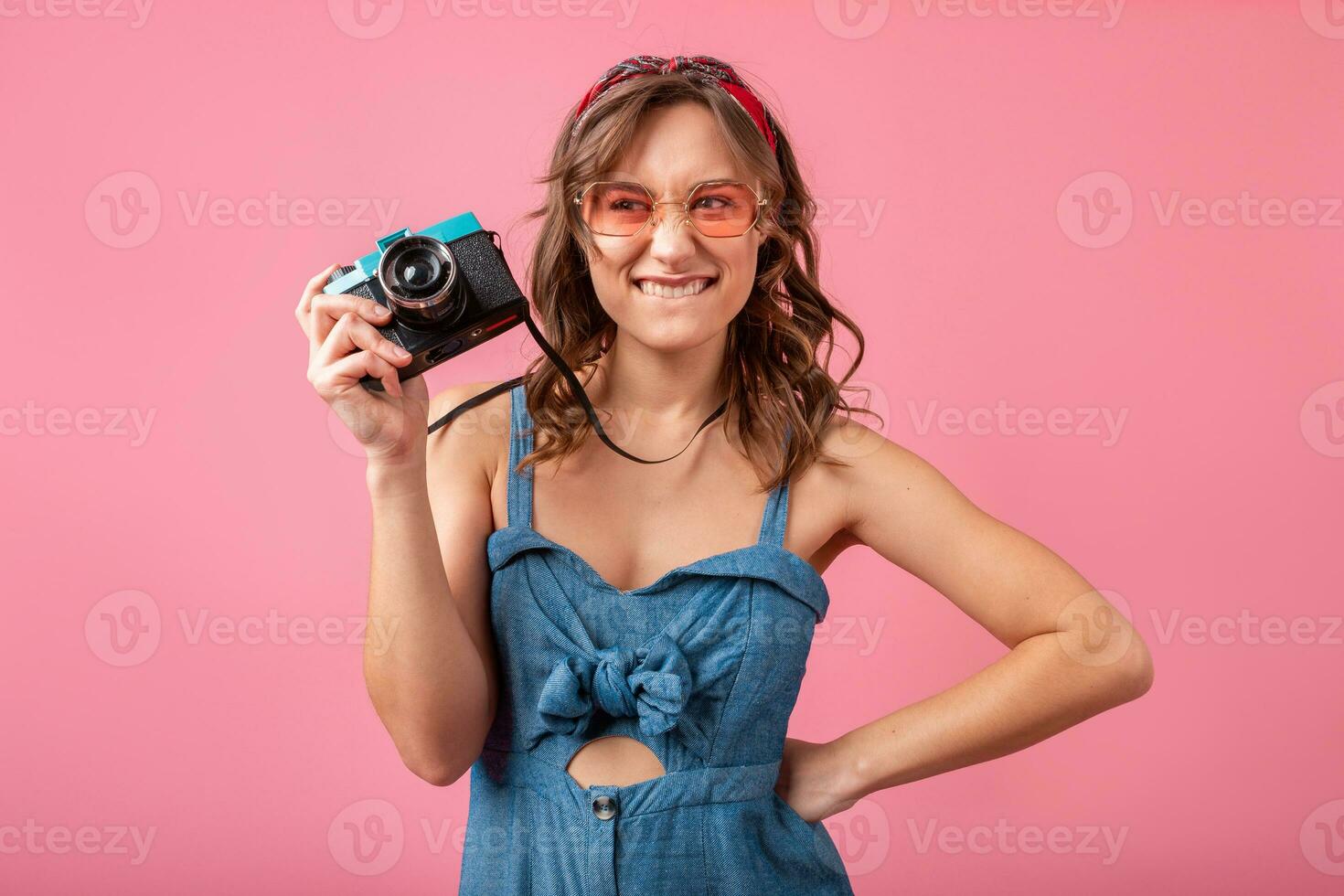 attractive smiling happy woman posing with vintage photo camera