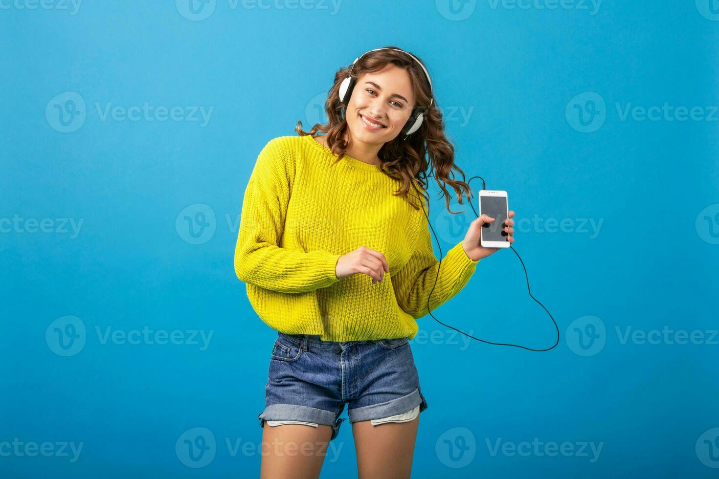 atractivo mujer en alegre salido estado animico escuchando a música en auriculares foto