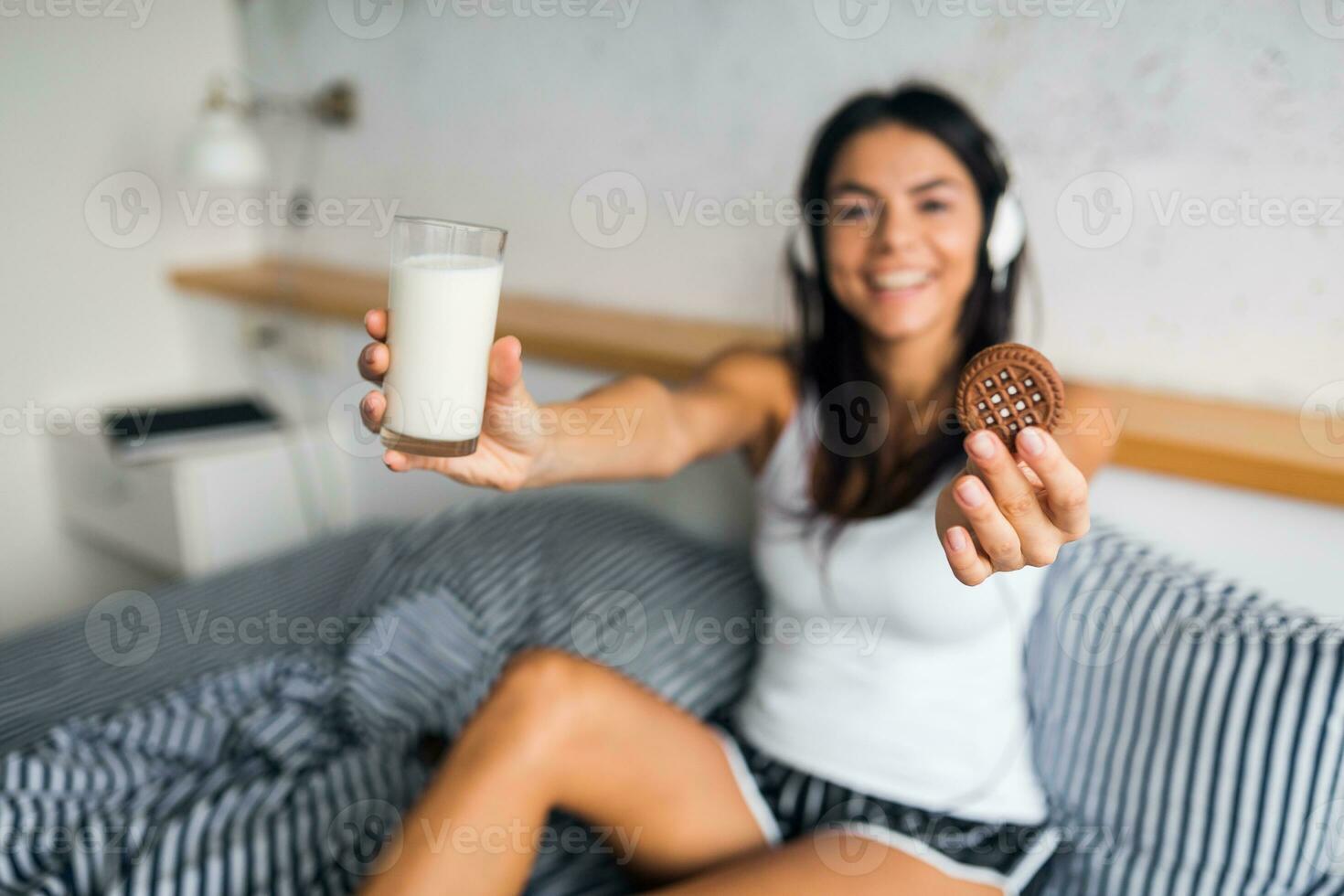 pretty sexy smiling woman sitting in bed in morninga photo