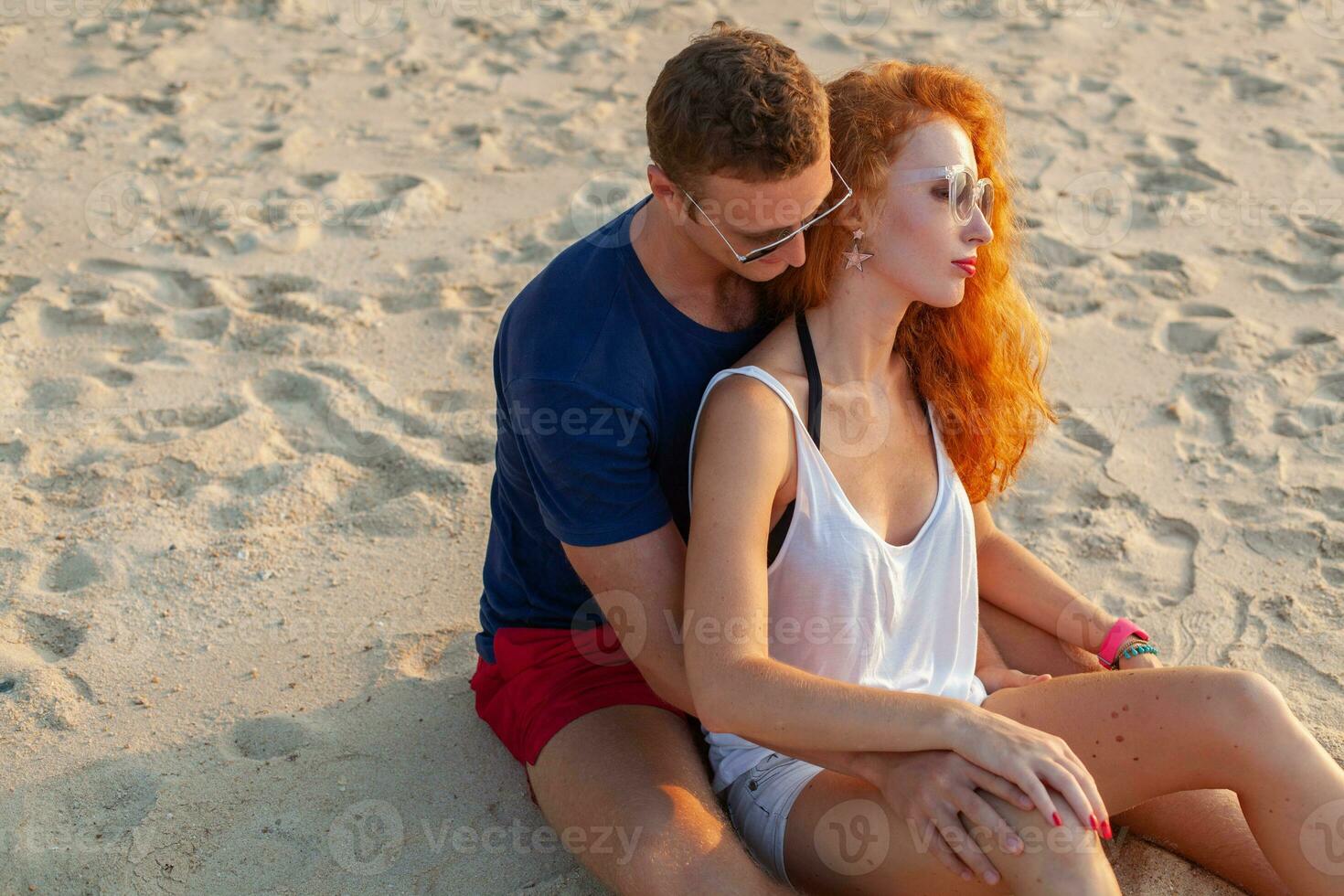 young couple in love happy on summer beach together having fun photo