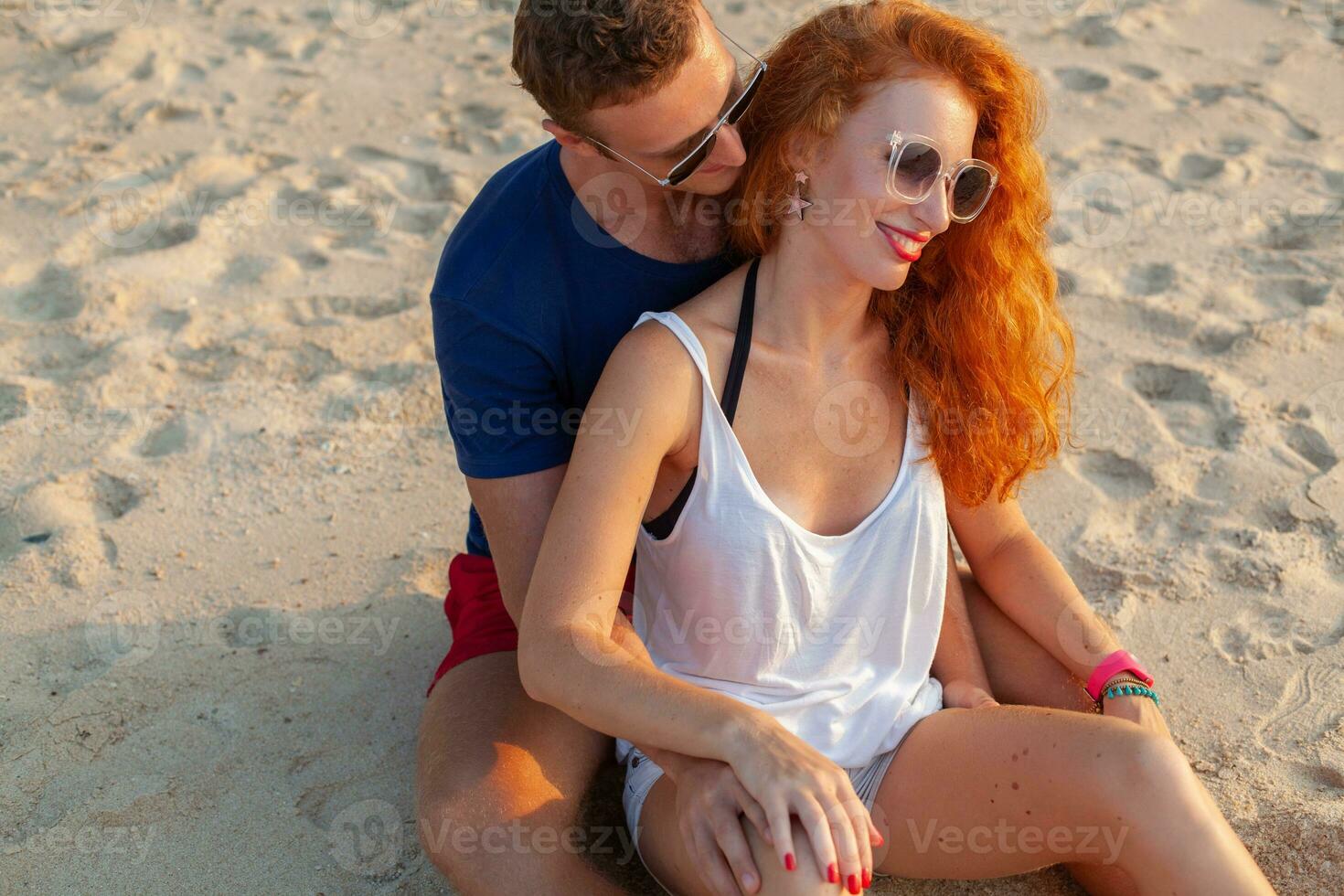 young couple in love happy on summer beach together having fun photo