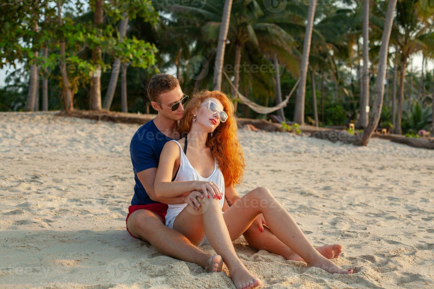 young couple in love happy on summer beach together having fun photo