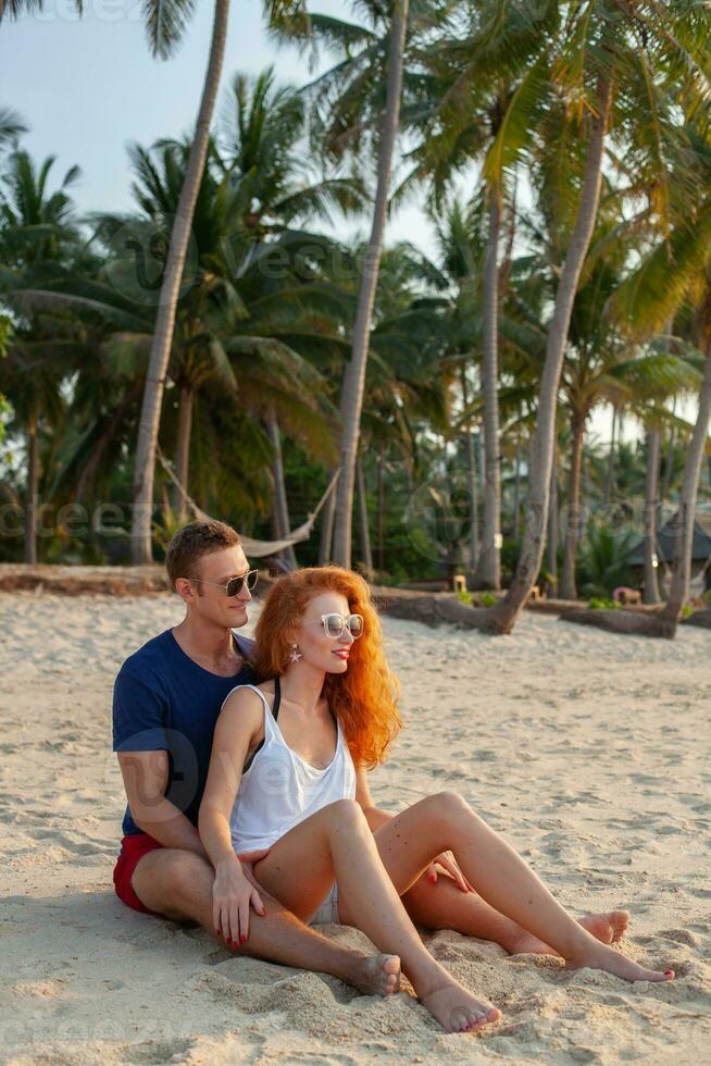 young couple in love happy on summer beach together having fun photo