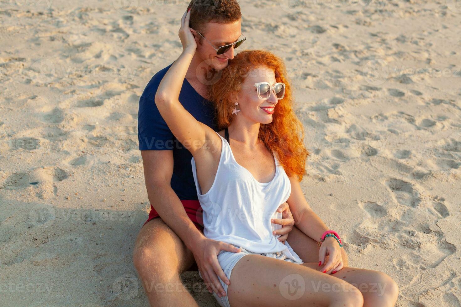 young couple in love happy on summer beach together having fun photo