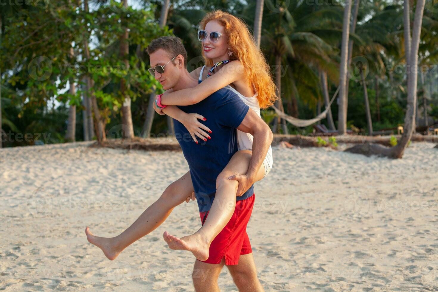 young couple in love happy on summer beach together having fun photo