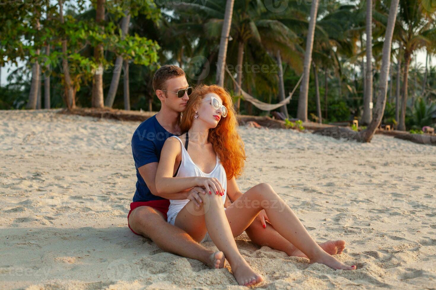 young couple in love happy on summer beach together having fun photo