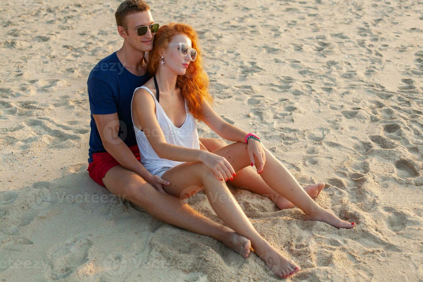 young couple in love happy on summer beach together having fun photo