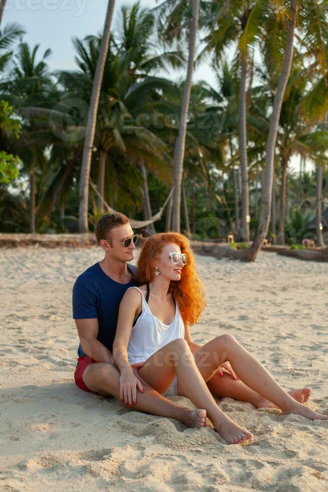 young couple in love happy on summer beach together having fun photo