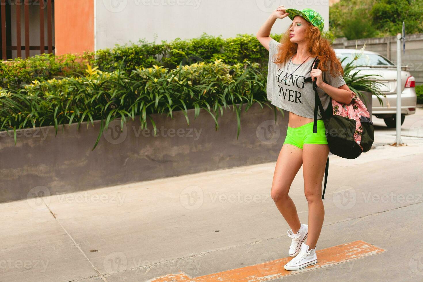 young stylish hipster ginger woman, walking in street photo