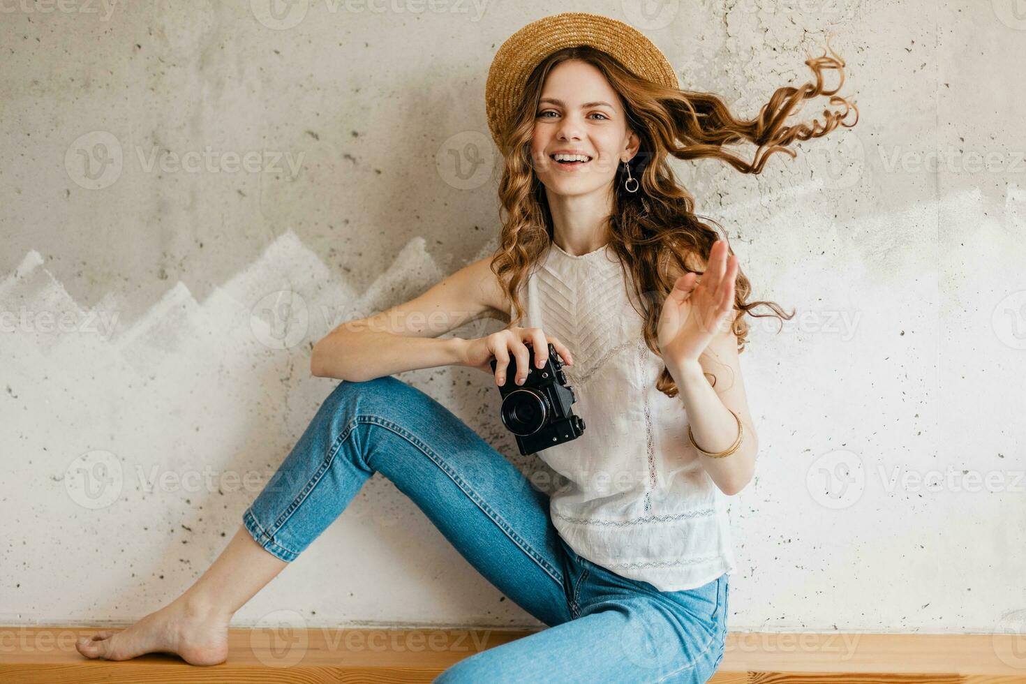 young pretty smiling happy woman wearing blue denim jeans and white shirt photo