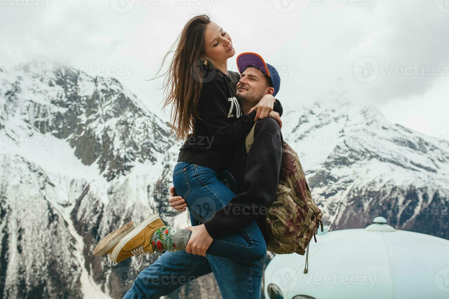 young hipster couple in love on winter vacation in mountains photo