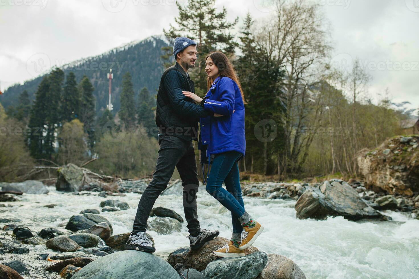 young hipster couple in love on winter vacation in mountains photo