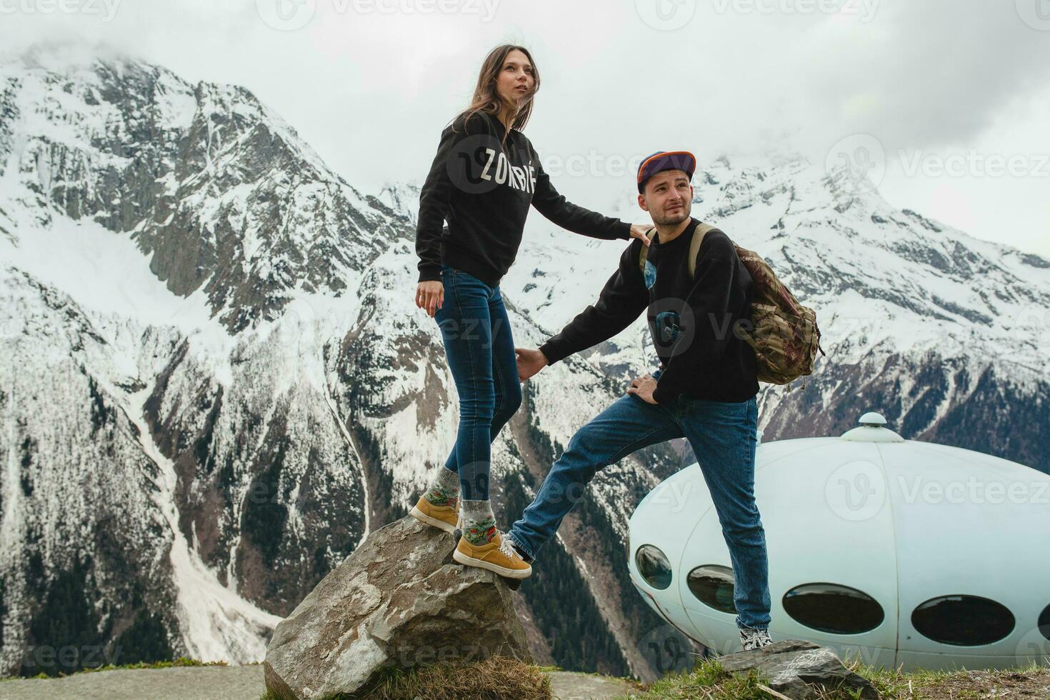 young hipster couple in love on winter vacation in mountains photo