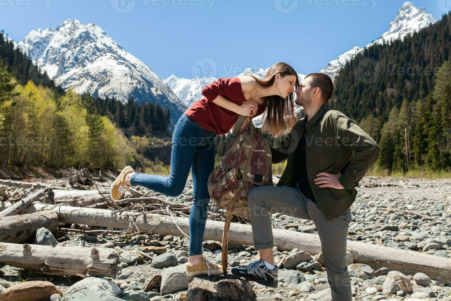 young hipster couple in love on winter vacation in mountains photo