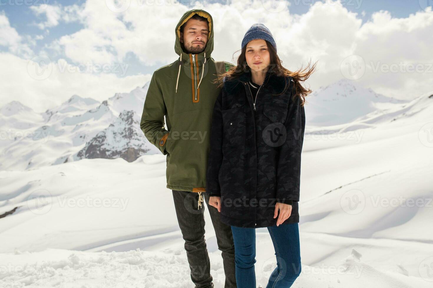 young beautiful hipster couple hiking in mountains photo