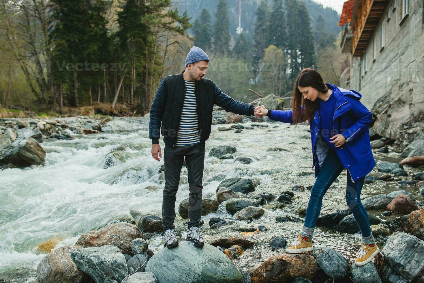 young hipster couple in love on winter vacation in mountains photo