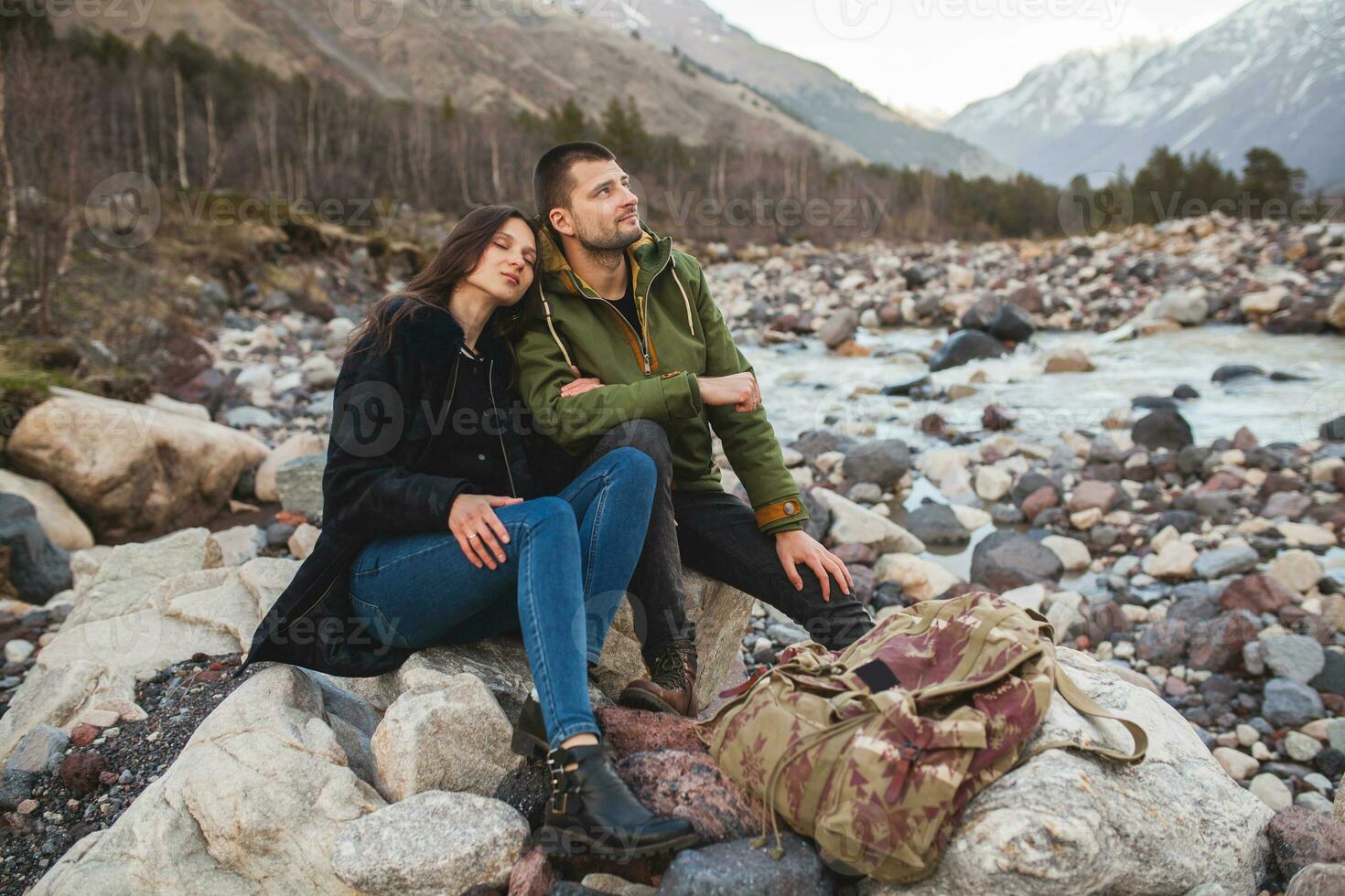 young beautiful hipster couple hiking in mountains photo