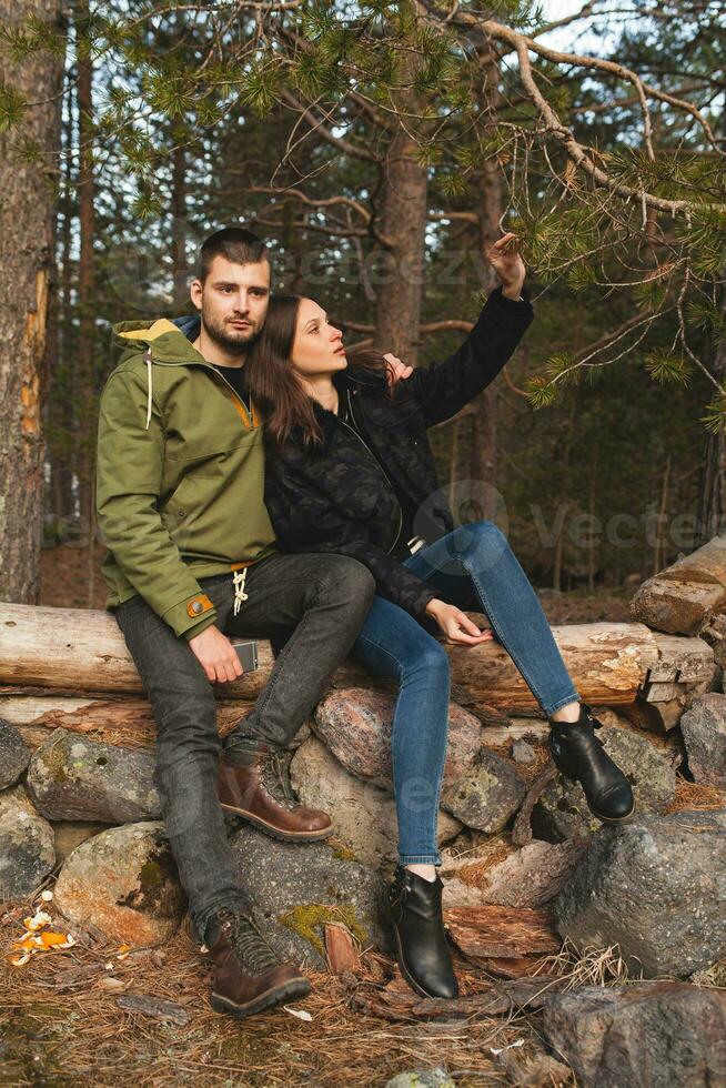 young beautiful hipster couple hiking in mountains photo