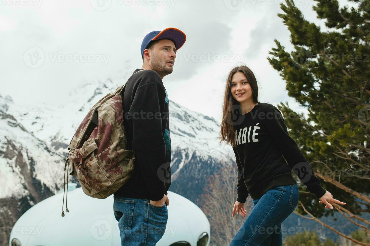 young hipster couple in love on winter vacation in mountains photo