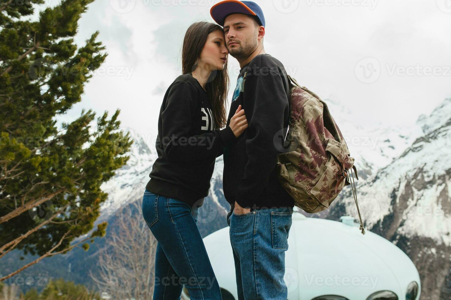 young hipster couple in love walking in mountains photo