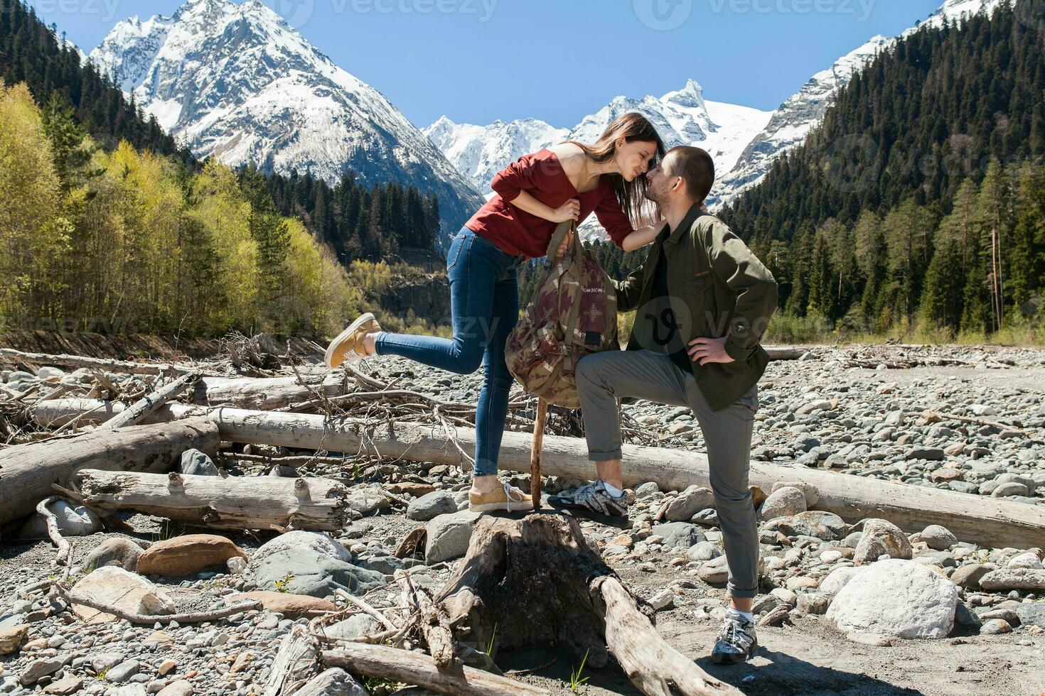 young hipster couple in love on winter vacation in mountains photo
