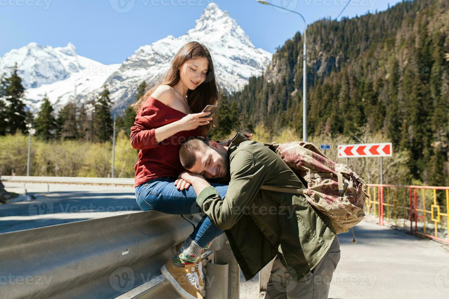 young hipster couple in love walking in mountains photo